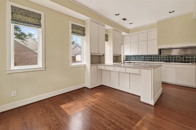 a kitchen with stainless steel appliances a refrigerator and a stove top oven
