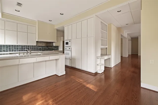a hallway view with wooden floor and staircase
