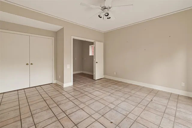 a view of a livingroom with an empty space and a ceiling fan