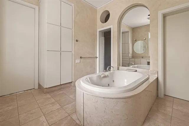 a bathroom with a double vanity sink mirror and next to a window