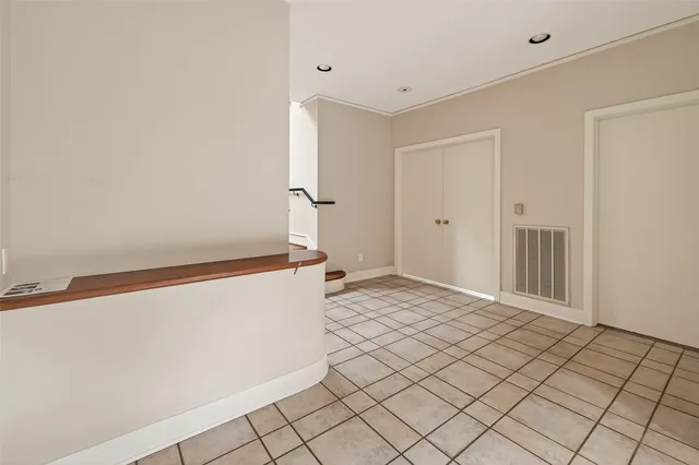 a view of a livingroom with white walls and stairs