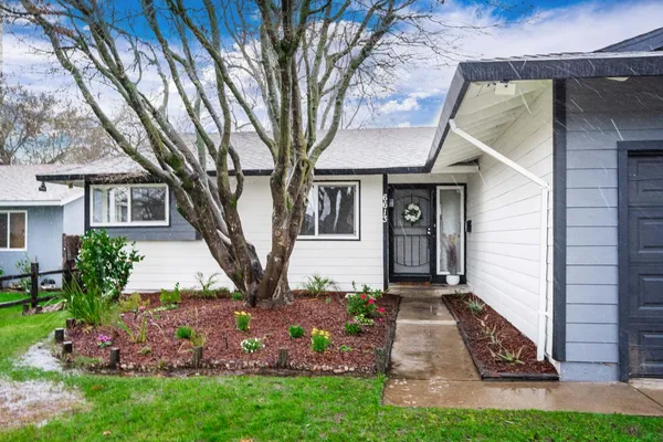 a front view of a house with garden