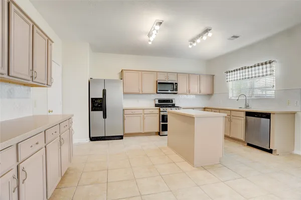 a kitchen with white cabinets and white appliances