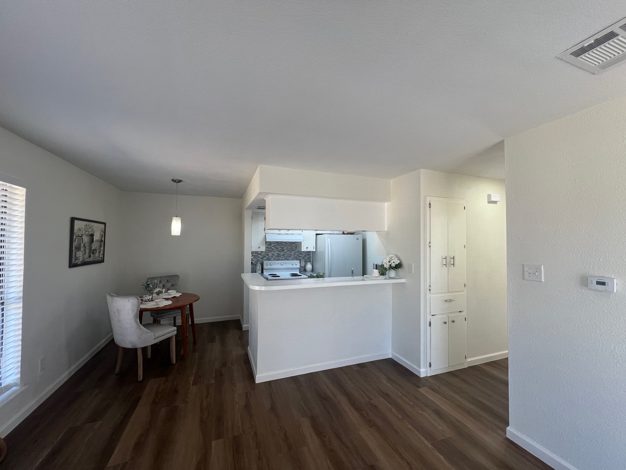 245 Mt Olive Road, Unit A & B Cedar Creek, TX 78612 - Photo 9 of 33 Unit B Kitchen featuring light countertops, freestanding refrigerator, a peninsula, dark wood style tile flooring, and electric range oven