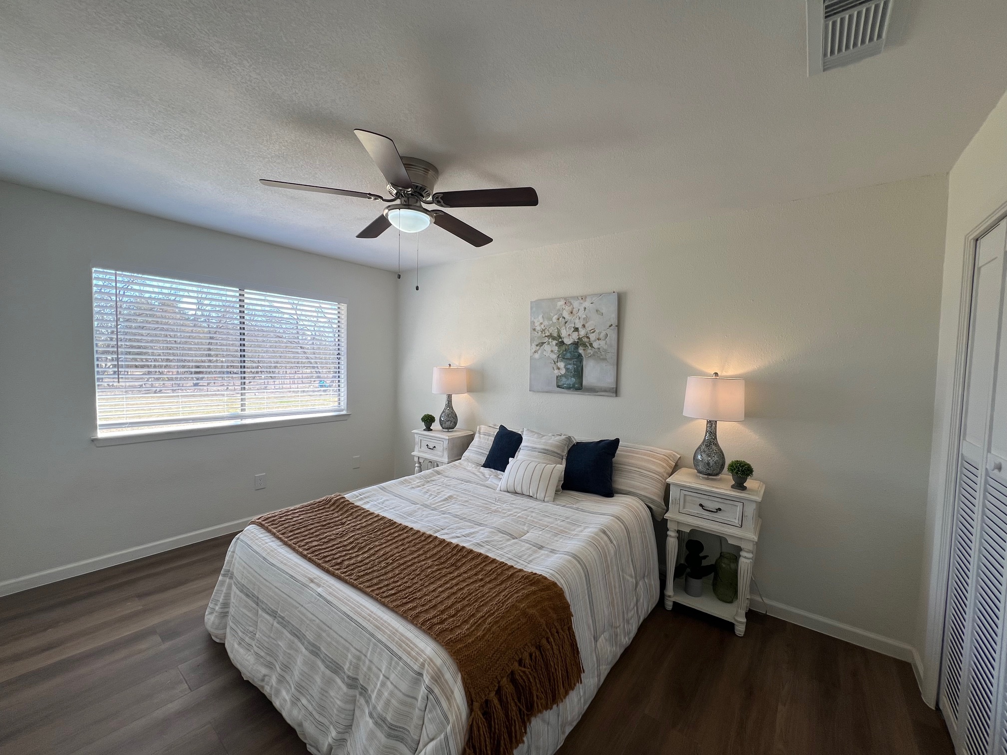 245 Mt Olive Road, Unit A & B Cedar Creek, TX 78612 - Photo 13 of 33 Unit B Bedroom with dark wood-style tile flooring, a ceiling fan, and a closet