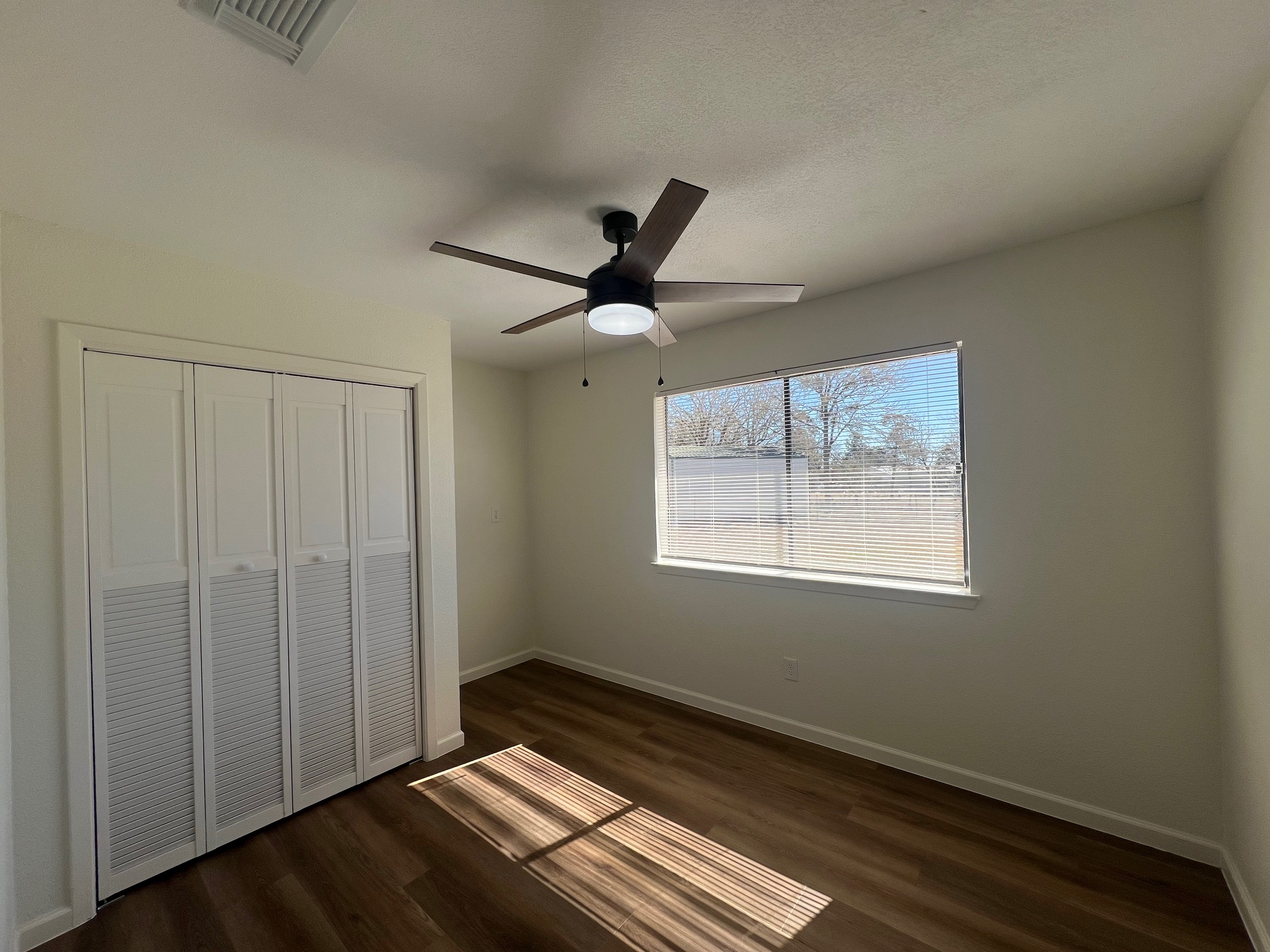 245 Mt Olive Road, Unit A & B Cedar Creek, TX 78612 - Photo 16 of 33 Unit B bedroom featuring dark wood finished floors, a closet, and ceiling fan