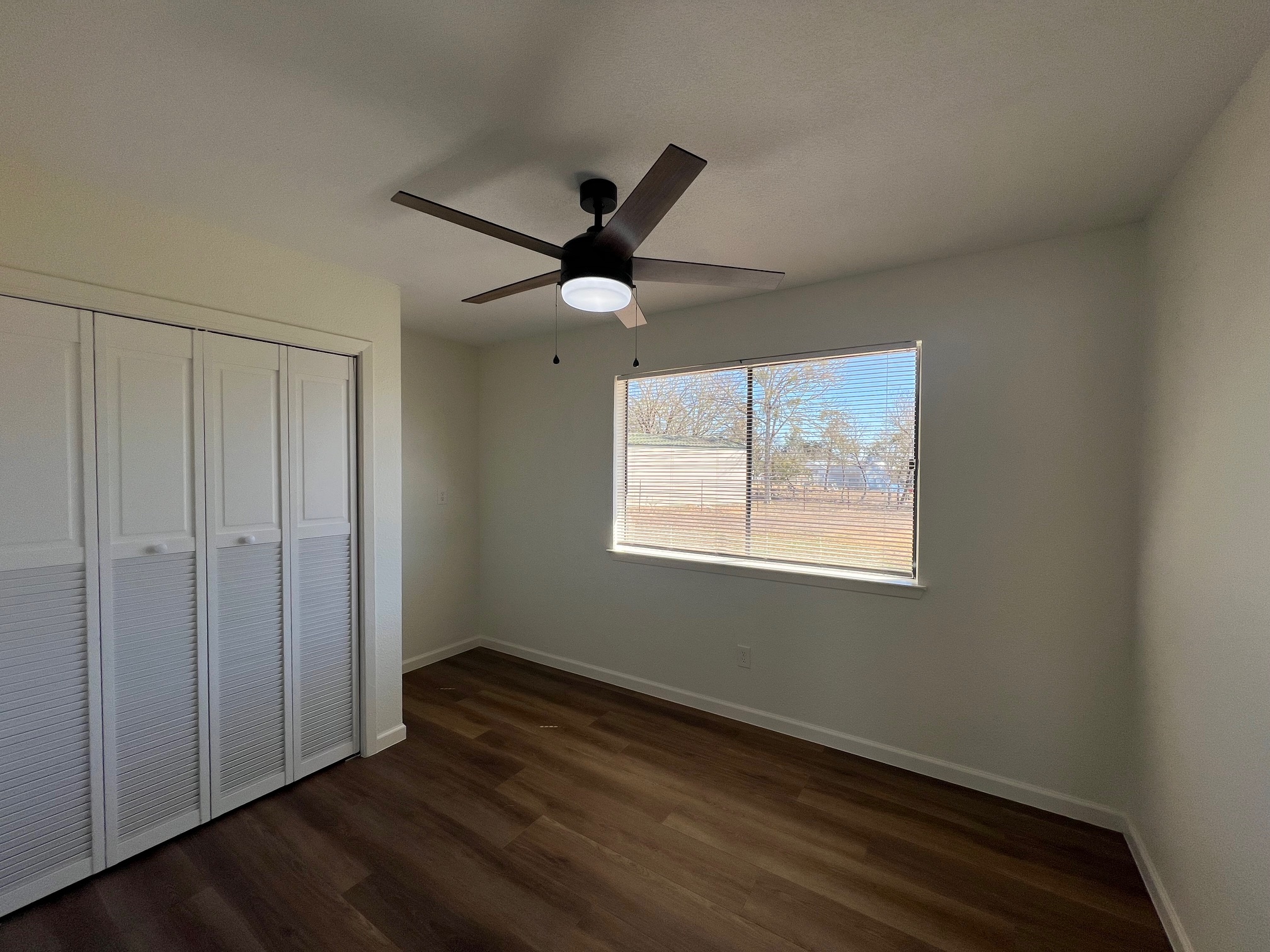 245 Mt Olive Road, Unit A & B Cedar Creek, TX 78612 - Photo 17 of 33 Unit B bedroom with a closet, dark wood-type flooring, and ceiling fan