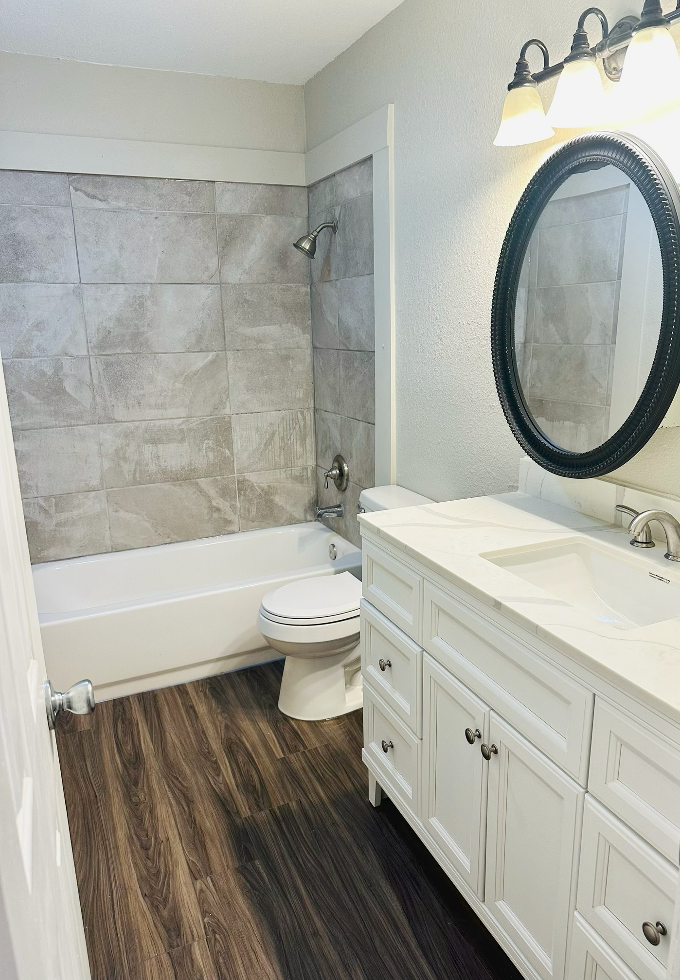245 Mt Olive Road, Unit A & B Cedar Creek, TX 78612 - Photo 24 of 33 Unit A Bathroom featuring vanity, shower / tub combination, dark wood-style floors, and a textured wall