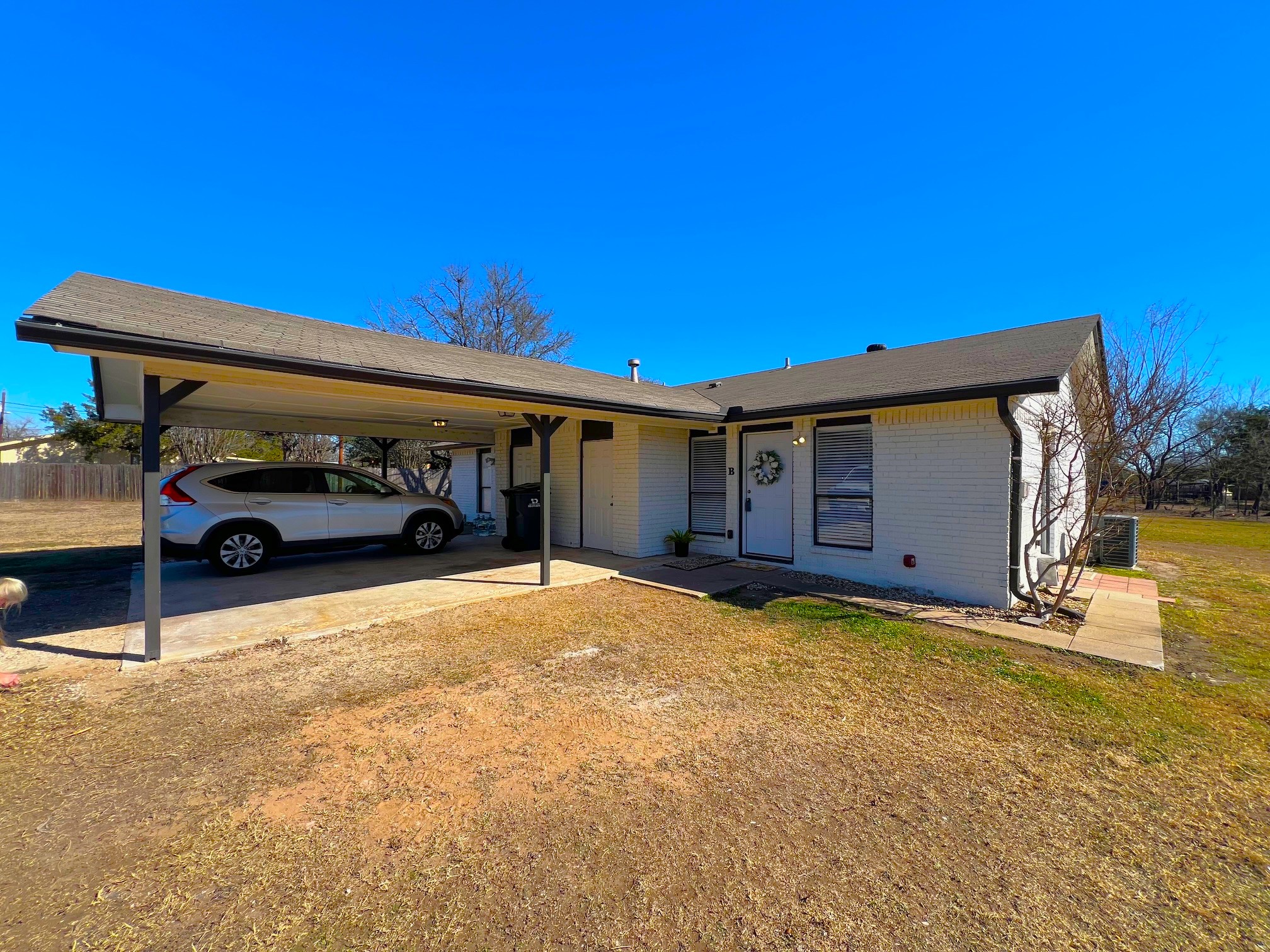 245 Mt Olive Road, Unit A & B Cedar Creek, TX 78612 - Photo 27 of 33 Exterior Unit B with an attached carport,Launry Room, brick siding, and driveway