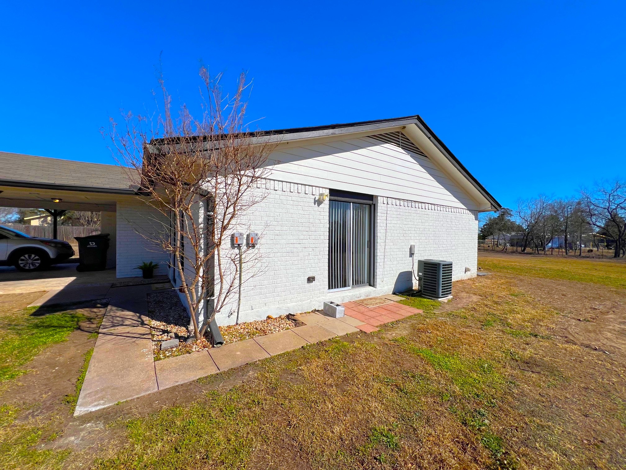 245 Mt Olive Road, Unit A & B Cedar Creek, TX 78612 - Photo 28 of 33 Unit B side of Duplex with a lawn, brick siding, and an attached carport