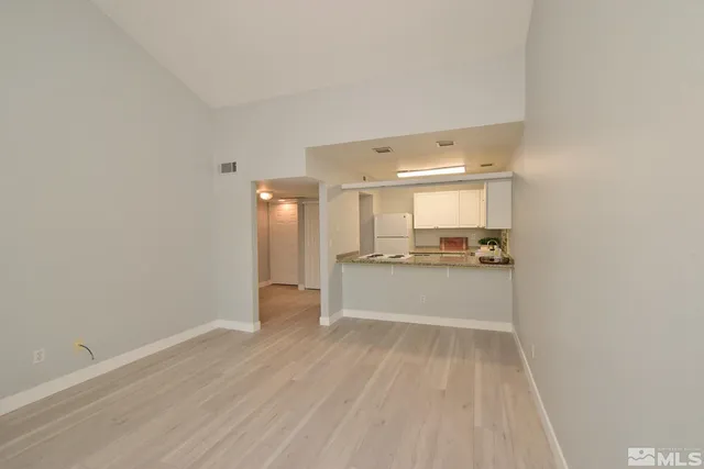 a view of a kitchen with white cabinets