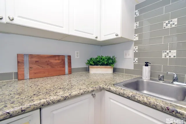 a kitchen with granite countertop a sink and a granite counter tops