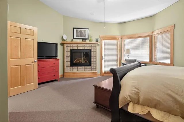 a bedroom with furniture and a fireplace