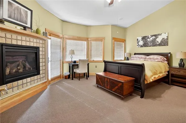 a spacious bedroom with a bed and a fireplace