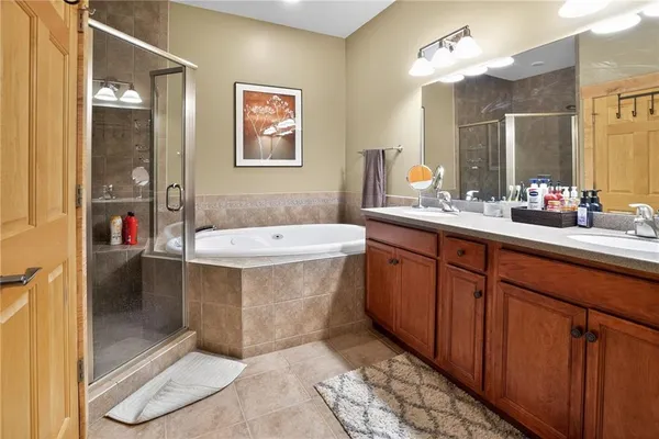a bathroom with a tub sink and mirror