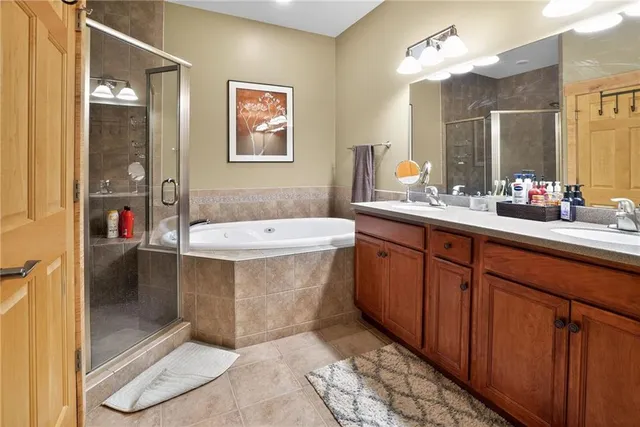 a bathroom with a tub sink and mirror