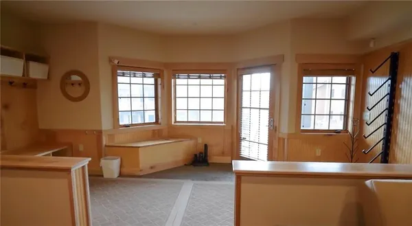 a living room with a bed furniture and a large window