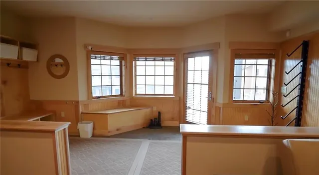 a living room with a bed furniture and a large window