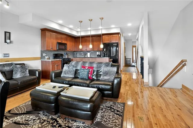a living room with furniture and a chandelier
