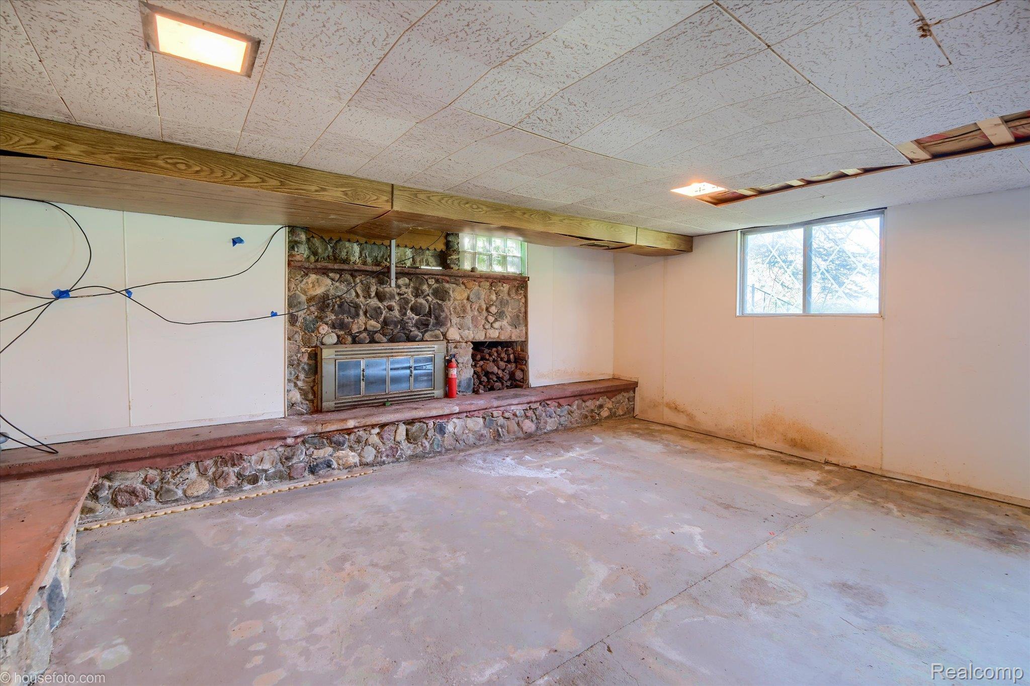1325 Barnes Lake Road North Branch, MI 48461 - Photo 26 of 42 Basement with a stone fireplace and healthy amount of natural light