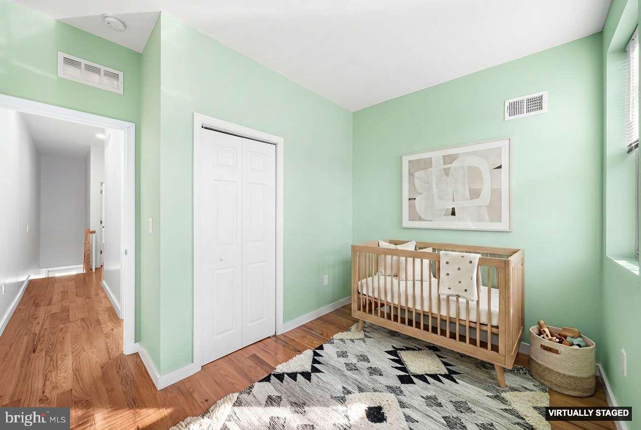 1346 South 46th Street Philadelphia, PA 19143 - Photo 17 of 32 a view of a bedroom with furniture and wooden floor