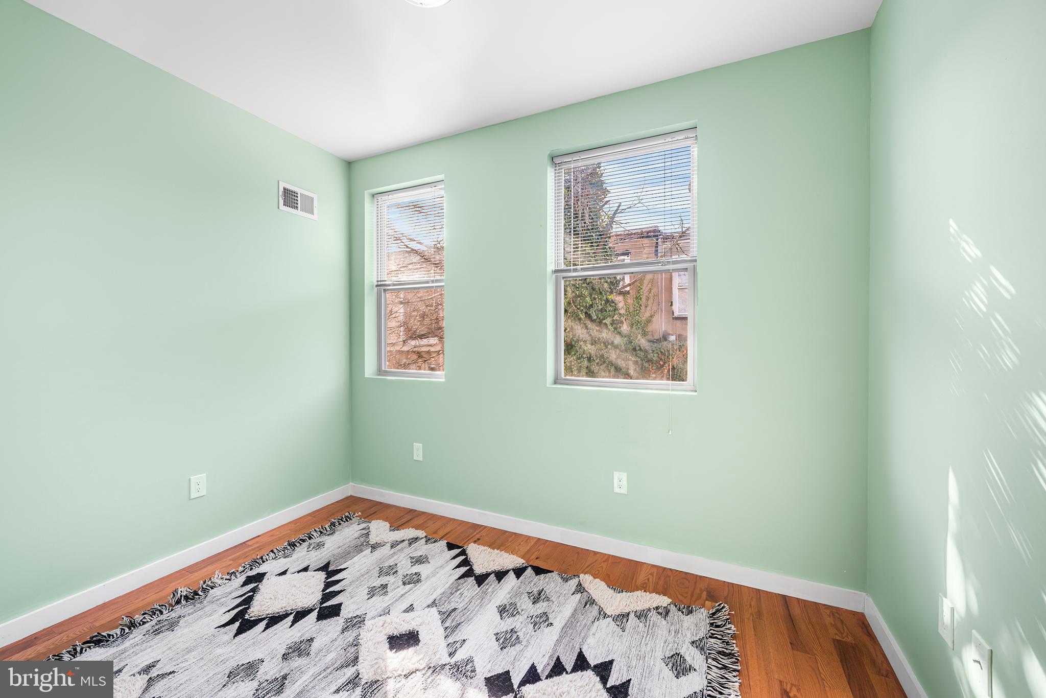 1346 South 46th Street Philadelphia, PA 19143 - Photo 18 of 32 a bedroom with bed and painting on the wall