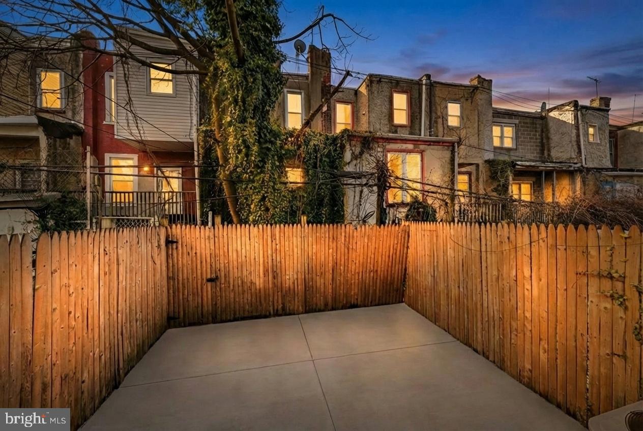 1346 South 46th Street Philadelphia, PA 19143 - Photo 30 of 32 a view of a brick house with a wooden fence