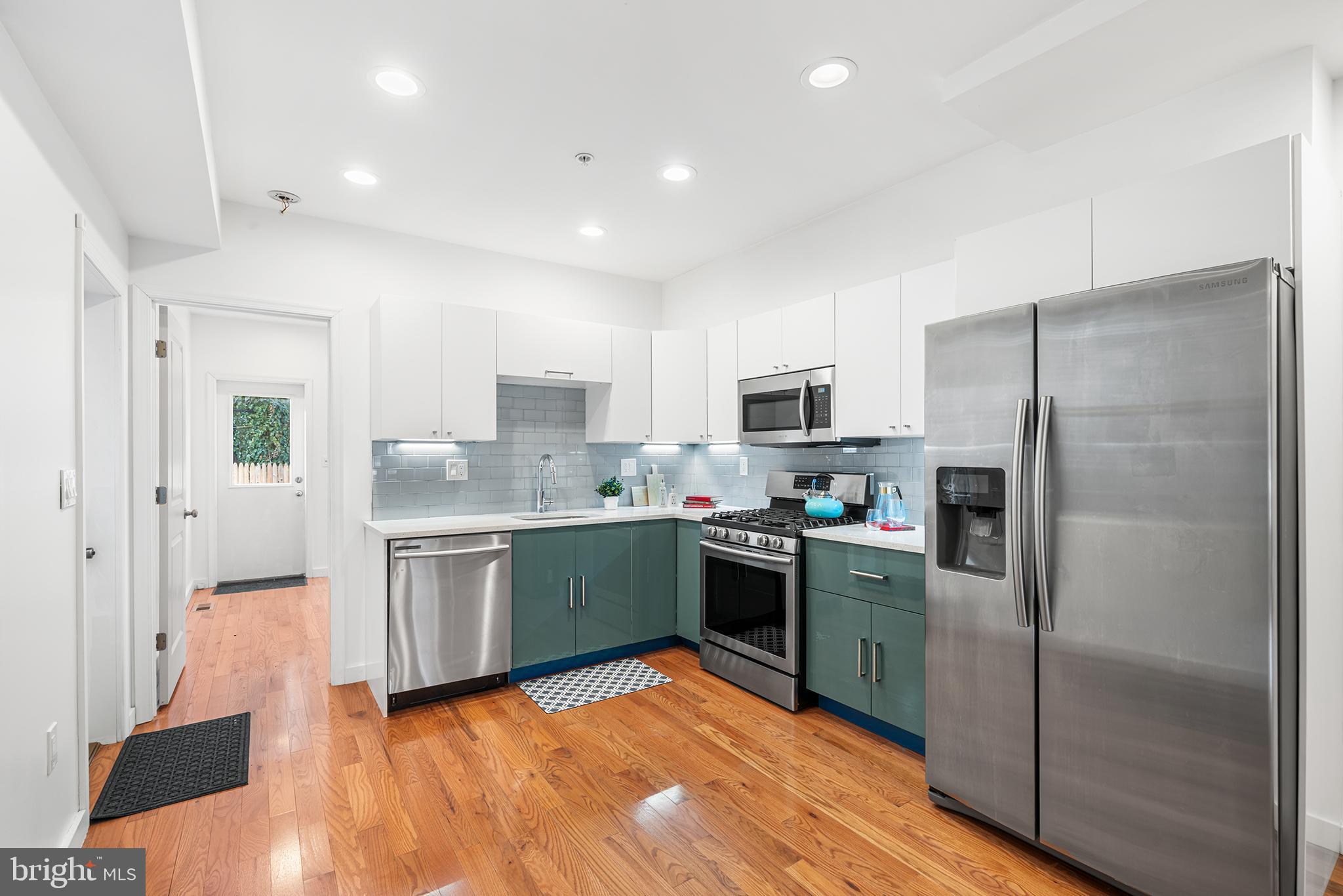 1346 South 46th Street Philadelphia, PA 19143 - Photo 10 of 32 a kitchen with granite countertop stainless steel appliances a refrigerator a stove top oven and sink