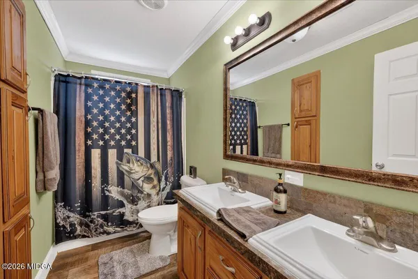 a bathroom with double vanity and a mirror