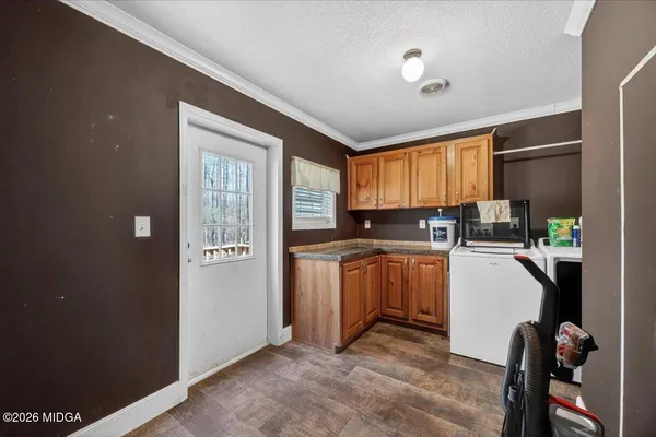 a kitchen with a refrigerator and a stove top oven