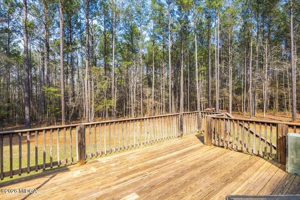 a view of a balcony with a floor to ceiling window and wooden floor