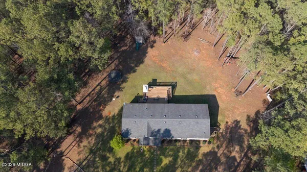 an aerial view of a house with yard and parking