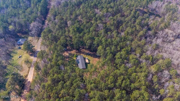 a view of house with yard and trees