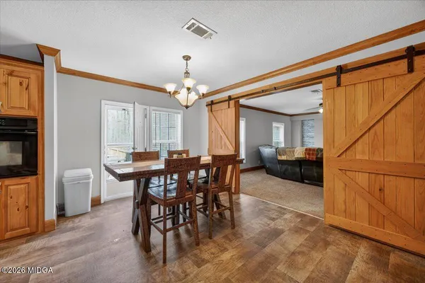 a view of a dining room with furniture and chandelier