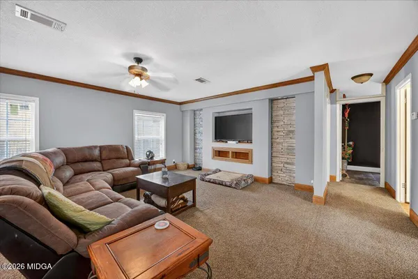 a living room with furniture and a flat screen tv