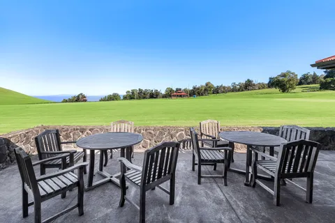 a table and chairs with the view of back yard