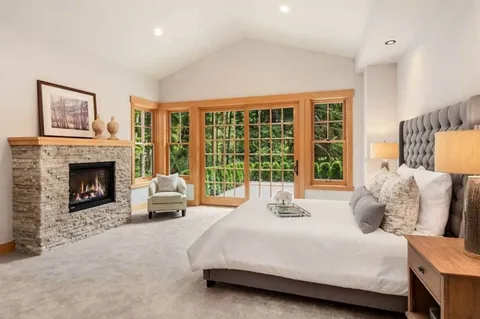 a bedroom with a bed and a fireplace