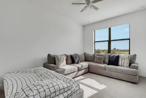 a bedroom with a bed a flat screen tv and a dresser