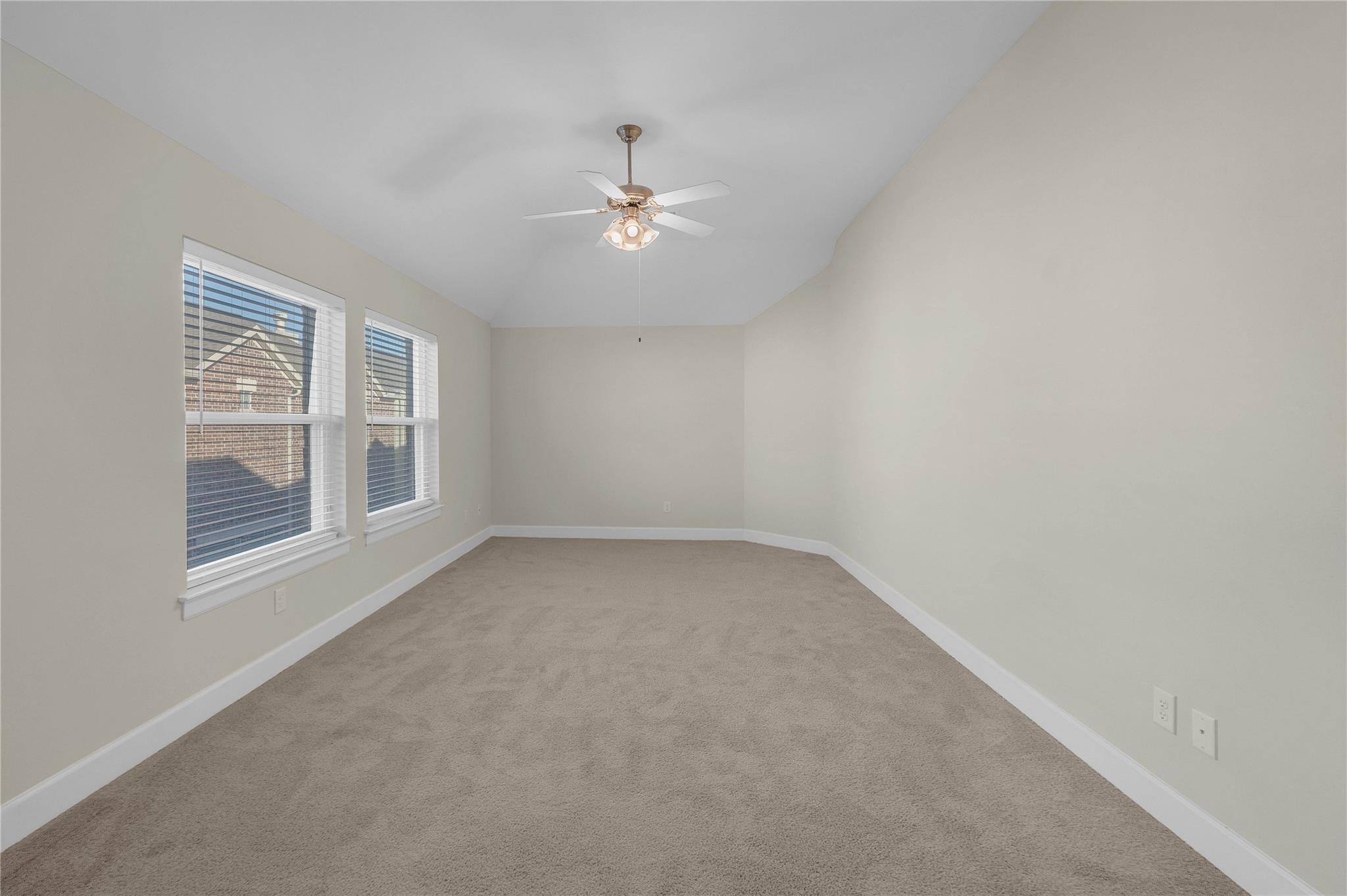 8731 Bryam Houston, TX 77061 - Photo 13 of 19 an empty room with chandelier fan and windows
