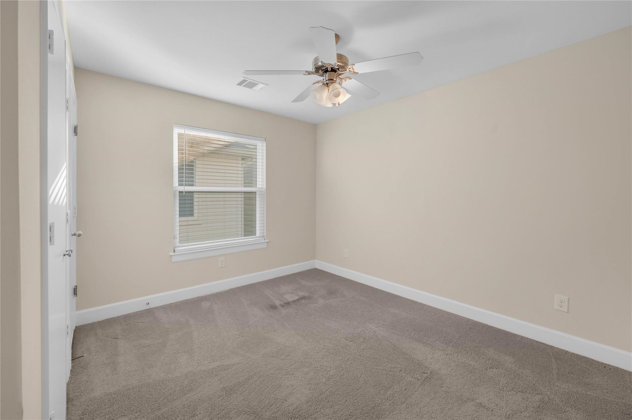 8731 Bryam Houston, TX 77061 - Photo 17 of 19 an empty room with windows and fan