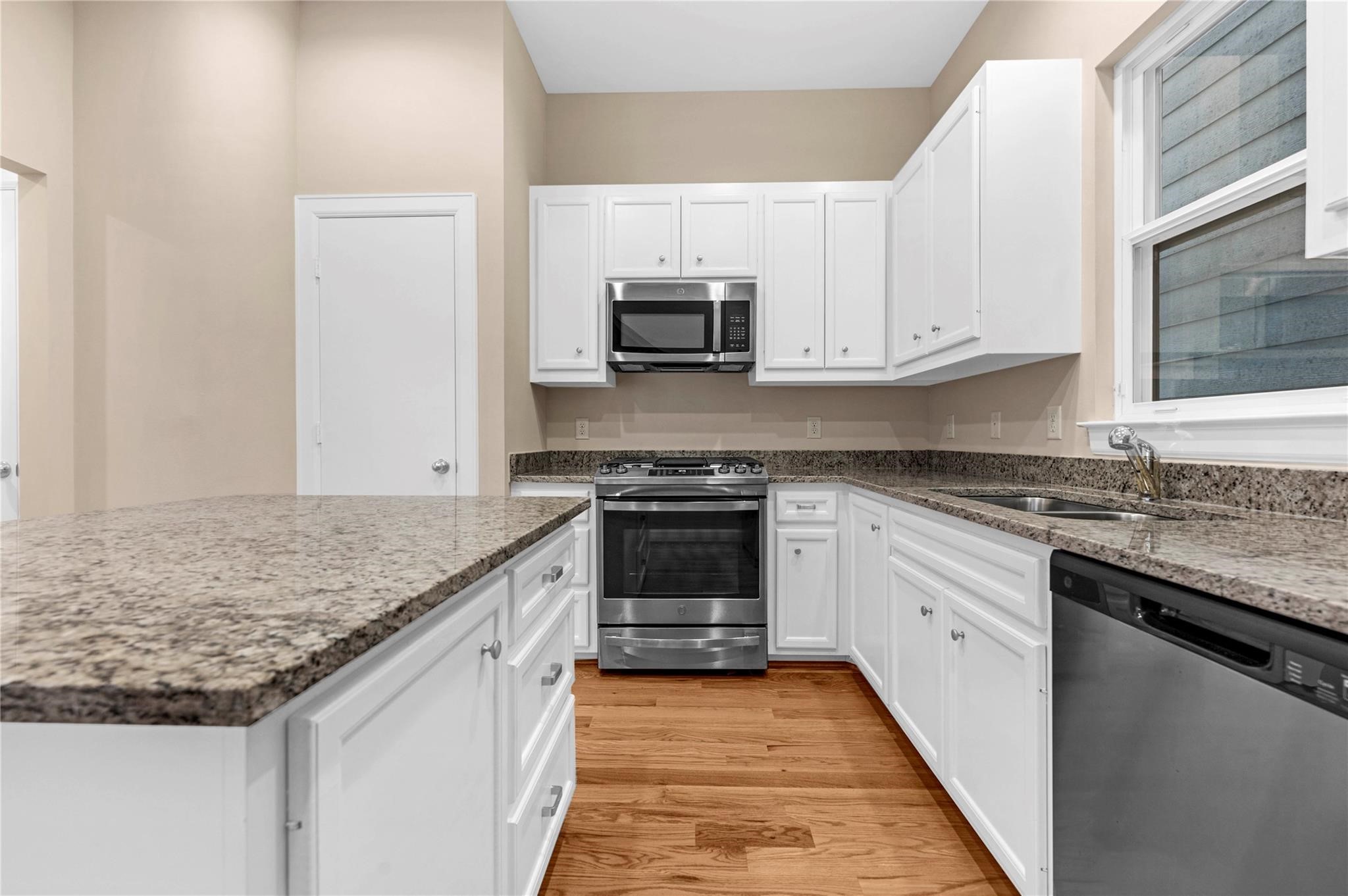 8731 Bryam Houston, TX 77061 - Photo 9 of 19 a kitchen with granite countertop a sink stove and cabinets