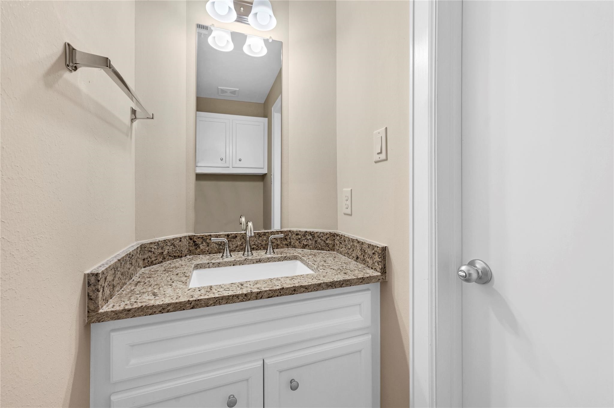 8731 Bryam Houston, TX 77061 - Photo 10 of 19 a bathroom with a granite countertop sink and a mirror