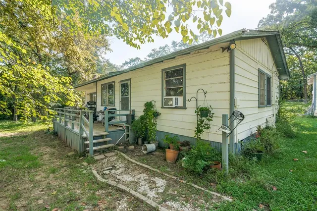 a backyard of a house with table and chairs