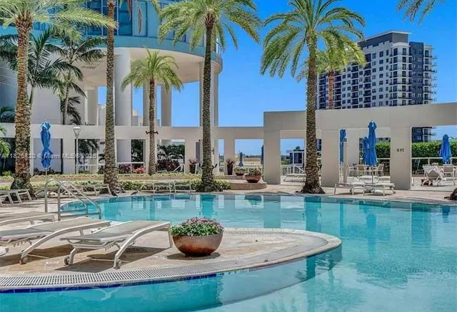 a view of an house with swimming pool and sitting area