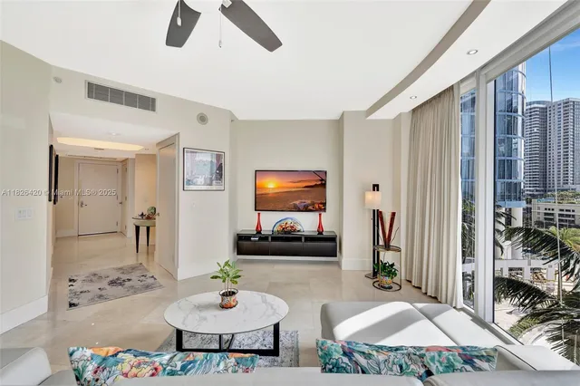 a kitchen with stainless steel appliances granite countertop a stove a refrigerator a dining table and chairs with wooden floor