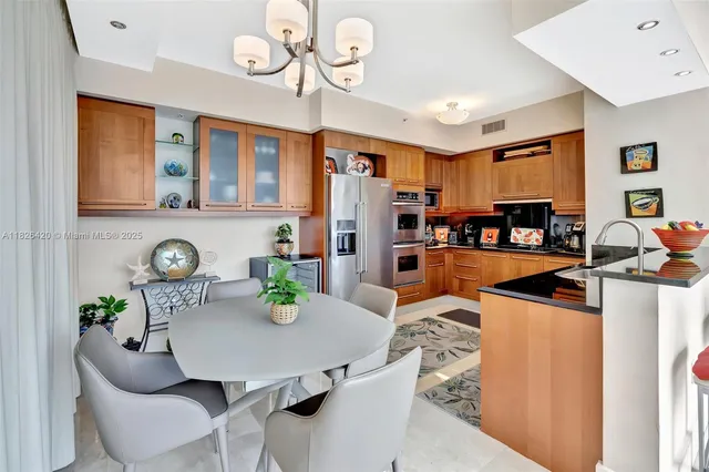 a living room with furniture kitchen view and a refrigerator