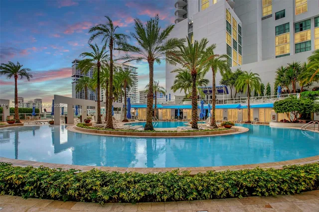 a view of a swimming pool with chair and tables