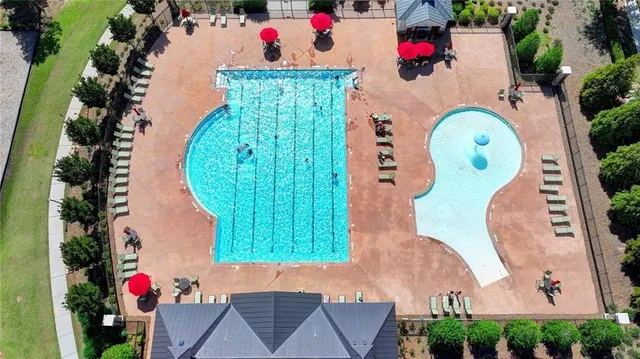 an aerial view of a tennis ground with large trees