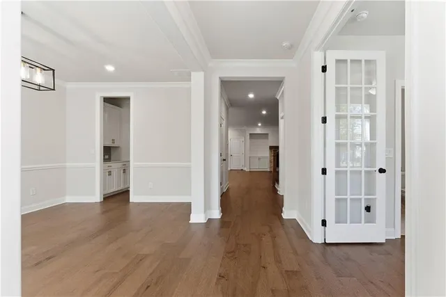 a view of a hallway with wooden floor