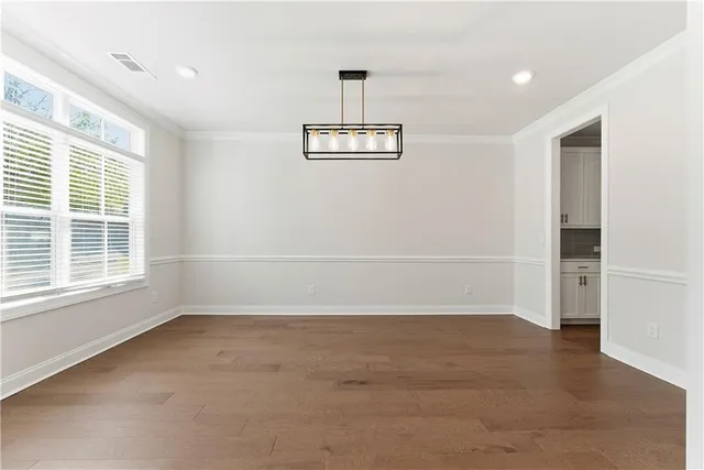 a kitchen with stainless steel appliances kitchen island wooden cabinets and a stove top oven